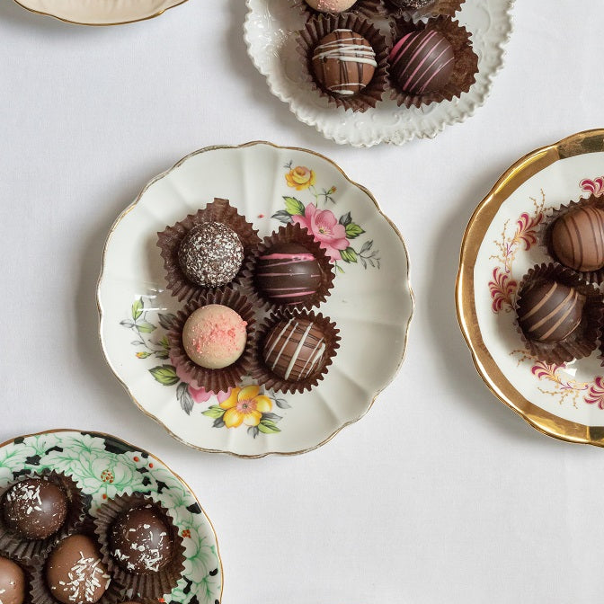 assortment of chocolate truffles on various dessert plates