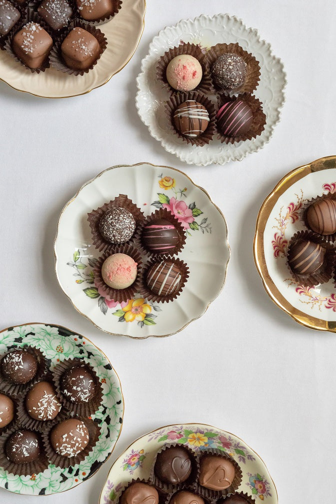 assortment of chocolate truffles on various dessert plates