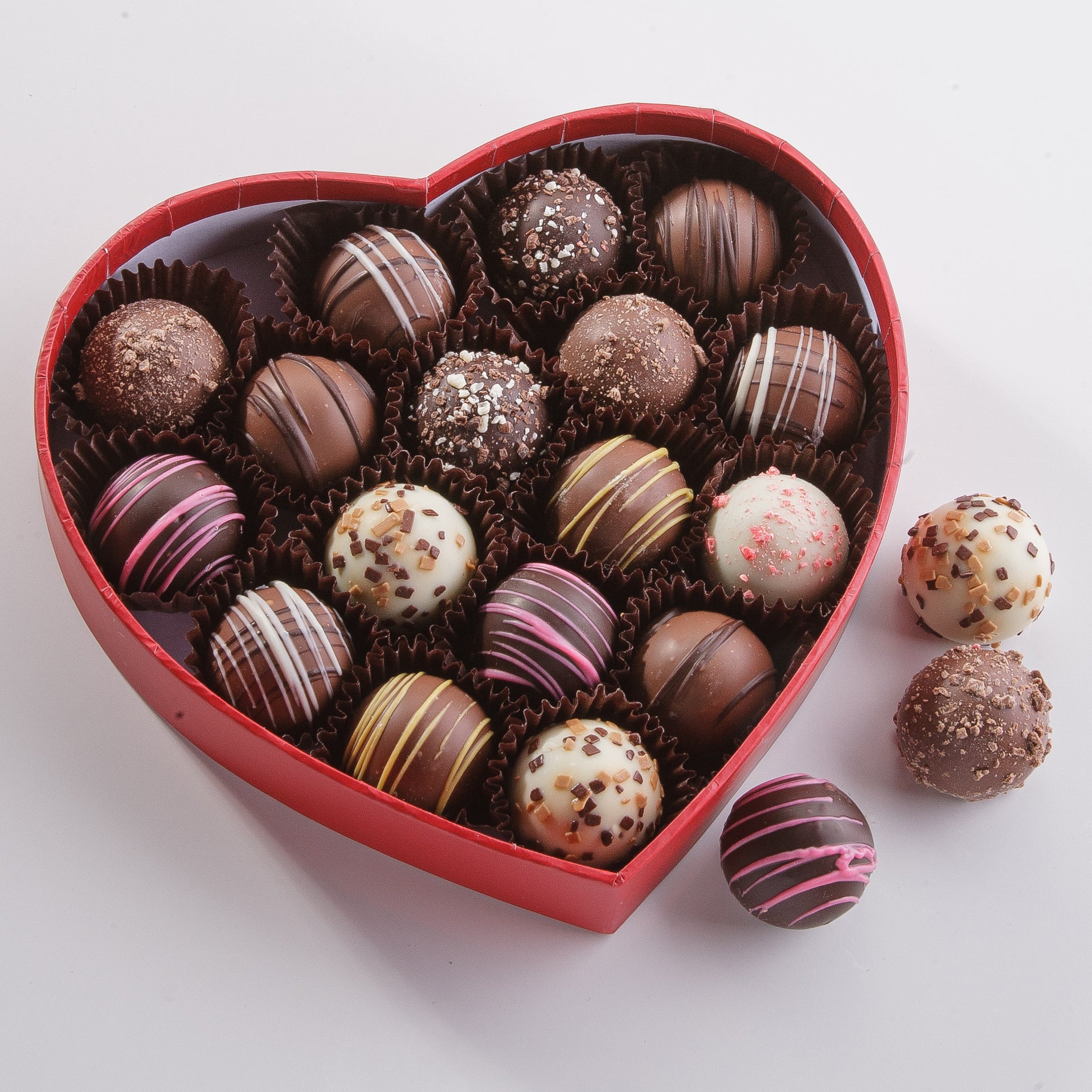 assorted truffles in a heart shaped container